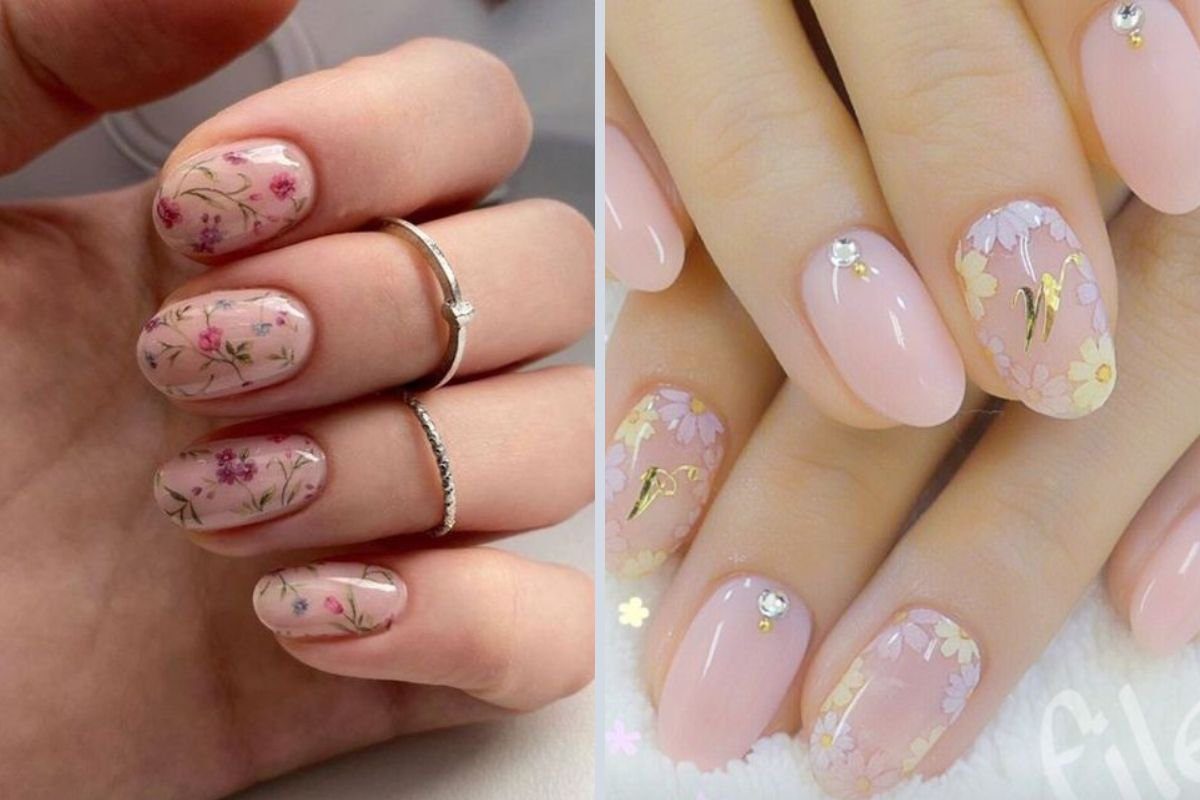 Unhas decoradas com esmalte rosa e desenhos florais delicados, adornadas com pequenos cristais e detalhes dourados.