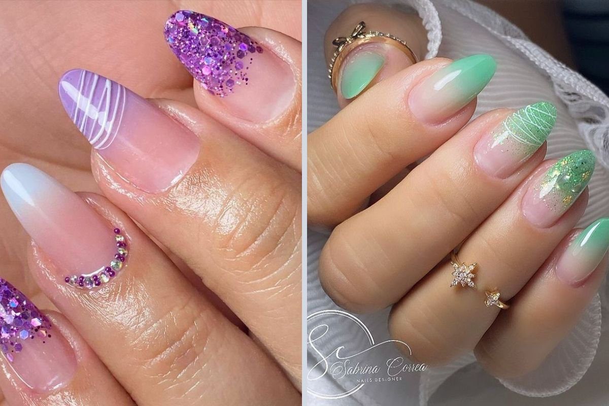 Duas mãos com unhas decoradas em tons de roxo e verde, com glitter, linhas e degradê.