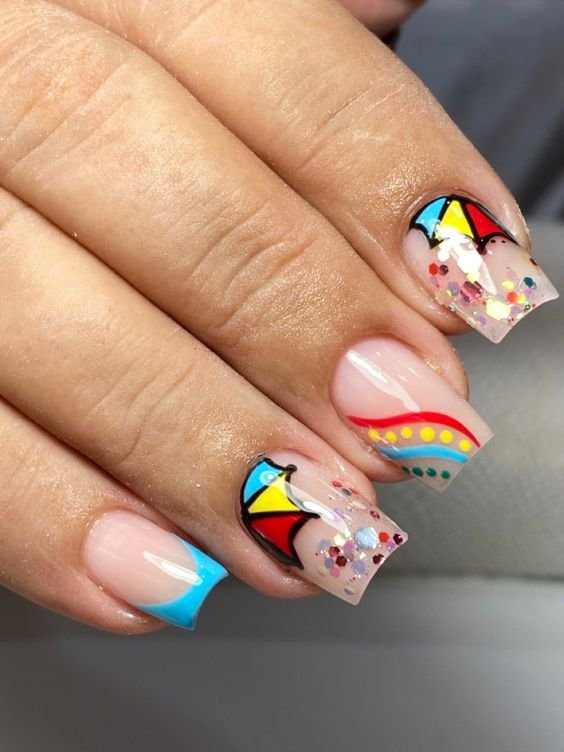 aposte-em-desenhos-para-as-inspiracoes-de-unhas-de-carnaval Unhas decoradas com desenhos coloridos de pipas e glitter, em estilo artístico e vibrante.
