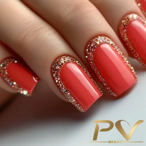 Unhas com esmalte rosa e bordas com glitter dourado.