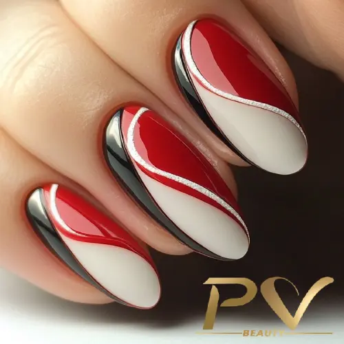 Unhas decoradas com esmalte vermelho, branco e preto, formando um design abstrato e elegante.