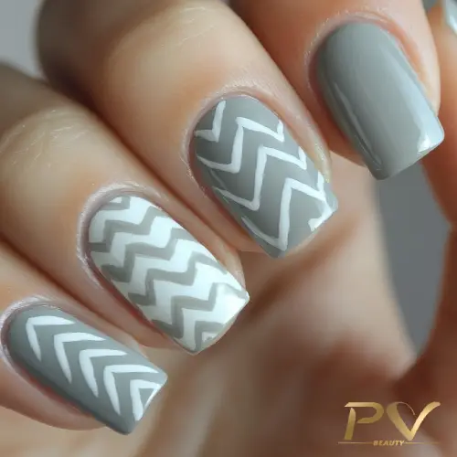unhas-cinza-designer-de-unhas-pv-beauty-01 Unhas com esmalte cinza e padrão geométrico em zigue-zague branco.