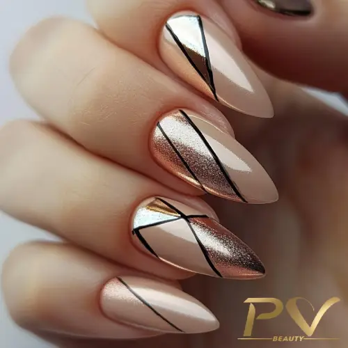 Unhas com esmalte nude e dourado, decoradas com linhas pretas geométricas e acabamento brilhante.
