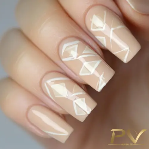 Unhas nude decoradas com linhas geométricas brancas, formando um design moderno e elegante.