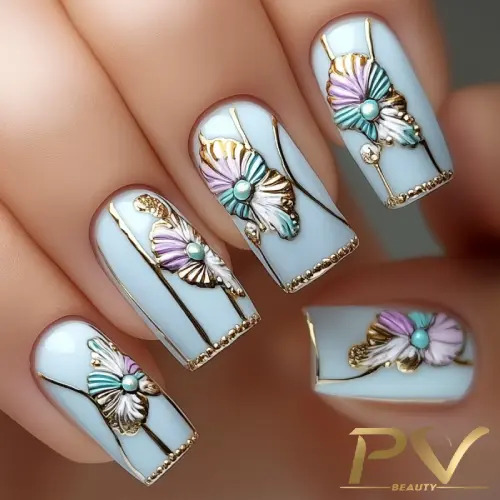 unhas-decoradas-branco-florais-metalicos-pv-beauty-24 Unhas decoradas com esmalte azul claro, detalhes dourados e aplicação de borboletas em tons pastel.