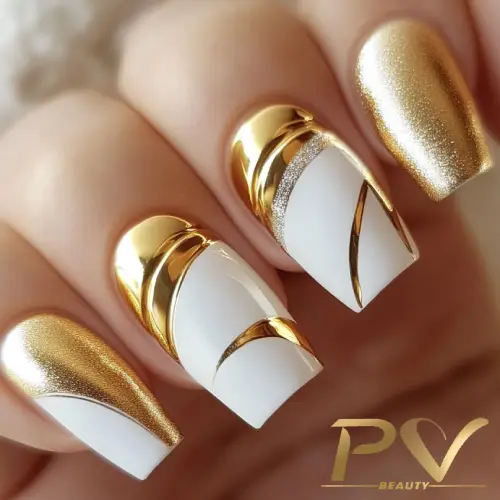 Unhas com esmalte dourado e branco, decoradas com linhas curvas metálicas.