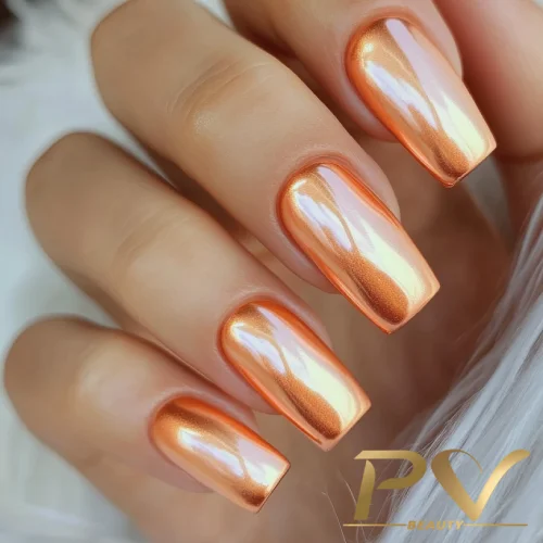 unhas-laranja-decoradas-esmalte-metalizado-pv-beauty-07 Unhas compridas com esmalte metálico laranja brilhante em mão feminina.