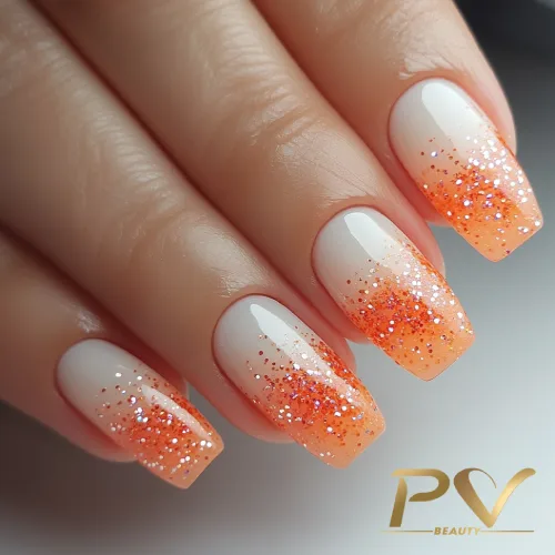 Unhas laranja com efeito ombré glitter em estilo moderno de nail art.