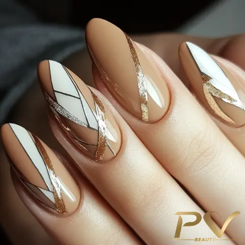 unhas-marrons-formas-geometricas-decoradas-pv-beauty-10 Unhas com esmalte marrom e branco, decoradas com linhas douradas e padrões geométricos.