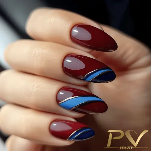 unhas-vinho-decoradas-azul-dourado-pv-beauty-20 Unhas pintadas em tons de vermelho e azul com detalhes em linha dourada.