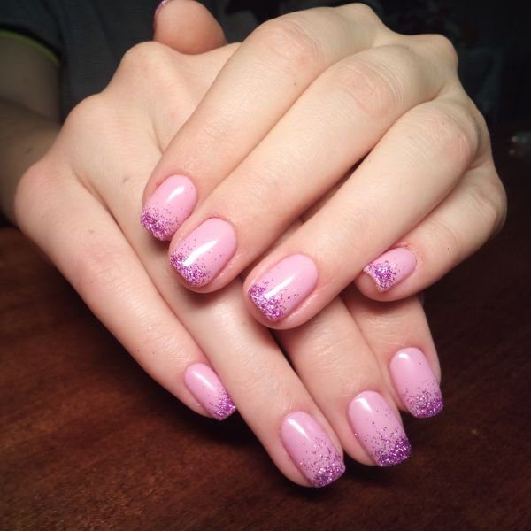 Unha rosa com pontas de glitter roxo em um design moderno e elegante.
